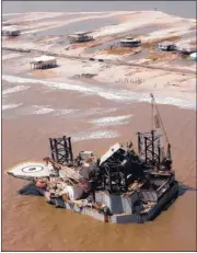  ?? PETER COSGROVE/ ASSOCIATED PRESS ARCHIVES ?? After Hurricane Katrina in 2005, an oil platform, ripped from its mooring in the Gulf of Mexico, was deposited on the shore in Dauphin Island, Ala. The island, home to 1,300 residents, has received more than $ 150 million in federal disaster relief...