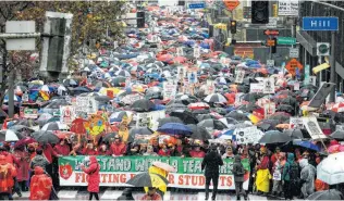  ?? Ringo H.W. Chiu / Associated Press ?? Thousands of teachers and supporters brave the rain during a rally Monday in Los Angeles. The city’s teachers went on strike Monday for the first time in three decades.