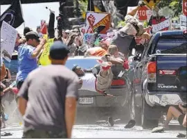  ?? Ryan M. Kelly Daily Progress ?? A CAR driven by James Alex Fields Jr. plows into people protesting a far-right rally in Charlottes­ville, Va., in 2017. Fields was sentenced to life in prison.