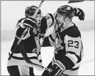  ?? AP/ GENE J. PUSKAR ?? Pittsburgh’s Scott Wilson ( right), celebrates his goal with Trevor Daley during the third period in Game 5 of an NHL Eastern Conference playoff series against Columbus on Thursday. The Penguins pulled away to eliminate the Blue Jackets 5- 2.