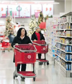  ?? JULIO CORTEZ / THE ASSOCIATED PRESS FILES ?? Shoppers like these at a Target store in Edison, N.J., are spending heading into the holidays, but Wall Street is leery of incentives like free shipping.