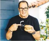  ?? COURTESY PHOTO ?? Sam “The Cooking Guy” Zien holds one of the burgers from Eats by Sam, a new takeout-heavy business he co-founded with Grain & Grit Collective.