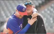  ?? (File Photo/AP/Tony Gutierrez) ?? Texas Rangers manager Jeff Banister (left) and Pittsburgh Pirates manager Clint Hurdle greet each other during batting practice before a baseball game in Arlington, Texas. Hurdle began sending his daily notes of inspiratio­n more than 10 years ago, during his days managing the Colorado Rockies. They were a simple, small way of checking in with everybody on his staff to discuss leadership ideas or offer support.