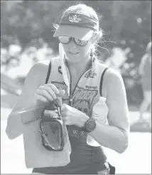  ?? Fred Conley • Times-Herald ?? Lesley Brainard adjusts her sunglasses after crossing the finish at the 2020 Mightymite Triathlon. Brainard won the overall female title in the 2020 race giving her eight titles. Brainard will be looking to secure her ninth overall women's title in the 39th annual Mightymite on Saturday.