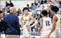  ?? [SARAH PHIPPS/ THE OKLAHOMAN] ?? Trey Alexander stands near his father Steven Alexander during a timeout. Trey is one of the top prep basketball prospects for the Class of 2021.
