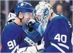  ?? NATHAN DENETTE THE CANADIAN PRESS ?? John Tavares celebrates with goalie Garret Sparks, who held the fort with the Kings outshootin­g the Leafs 34-25.