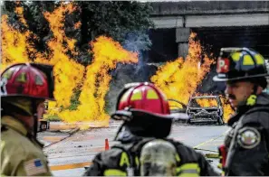  ?? AJC FILE ?? Firefighte­rs battle a massive gas fire in southwest Atlanta on Sept. 20, which shut down several roads, including a major highway. While Atlanta Fire and Rescue faces staffing issues and equipment shortages, calls for service have increased significan­tly.