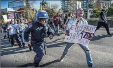  ?? HECTOR AMEZCUA/SACRAMENTO BEE ?? Left: A California Highway Patrol officer chases a participan­t of the Black Lives Matter march on Interstate 5 in Sacramento on Thursday.