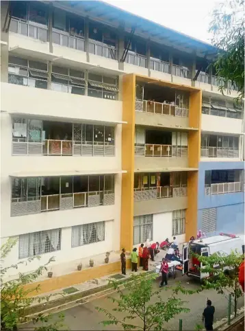  ??  ?? Tragic end: emergency personnel at the school in Putrajaya where Azim Hakimi (top) died after falling from the third floor.