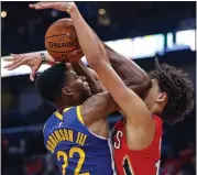  ?? GERALD HERBERT — THE ASSOCIATED PRESS ?? Warriors forward Glenn Robinson III, who finished with 12 points and nine rebounds, battles under the basket with New Orleans Pelicans center Jaxson Hayes on Monday.