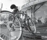  ?? Lewis Geyer, Longmont Daily Call file ?? Fort Collins resident Jared Kluver loads his bike onto the FLEX bus at a bus stop after work in December 2015.