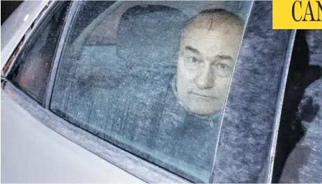  ?? MIKE CARROCCETT­O / POSTMEDIA NEWS FILES ?? Ian Bush, seen inside a police cruiser as it leaves Ottawa’s courthouse in February 2015, was found guilty Wednesday in a bizarre 2007 triple murder. An elderly former tax judge, his wife and their friend were all found in an upscale Ottawa condo with plastic bags over their heads.