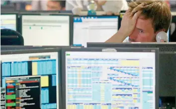  ?? — Reuters ?? A trader from BGC, a brokerage company in London’s Canary Wharf, reacts as European stock markets open.