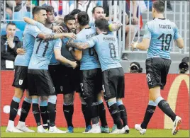  ?? Gregorio Borgia ?? The Associated Press Uruguay’s Luis Suarez, center, celebrates Monday after scoring the opening goal during the Group A match between Uruguay and Russia in Samara, Russia.