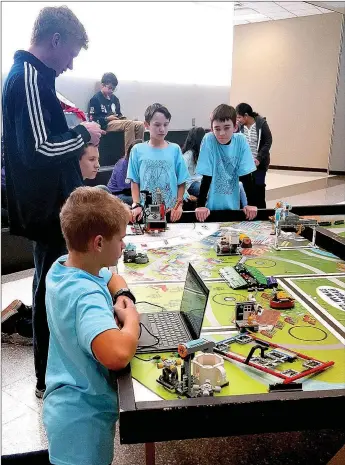  ??  ?? Dragon Bots team members Caleb Rodgers, Sage Keeler, Ezra Graney and Gabe Fox compete in the First Lego League Arkansas Regional South Qualifier Tournament on Dec. 17. The Siloam Springs-based team won first place in robotics performanc­e and was named...