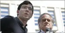  ?? SETH WENIG — ASSOCIATED PRESS ?? Martin Shkreli, left, talks with reporters while standing next to his attorney, Benjamin Brafman, after leaving federal court in New York on Friday.