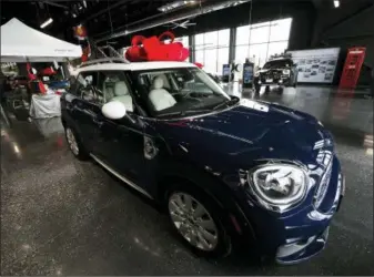  ?? DAVID ZALUBOWSKI — THE ASSOCIATED PRESS ?? A large red bow to mark the holiday season sits on the roof of an unsold 2019 Countryman on the floor of a Mini dealership in Highlands Ranch, Colo. Emotions run high when you’re buying a new or used car. So it’s easy to overlook details that could cost you in the long run.