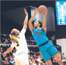  ?? Christina Leung ?? Stanford’s Maya Dodson goes up for a shot over USF’s Kia Vaalavirta. The Cardinal hit 15 of 32 three-point tries.