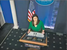  ?? The New York Times/DOUG MILLS ?? White House spokesman Sarah Huckabee Sanders reads a statement Wednesday from President Donald Trump on revoking former CIA Director John Brennan’s security clearance that said in part that “any benefits that senior officials might glean from consultati­ons with Mr. Brennan are now outweighed by the risk posed by his erratic conduct and behavior.”
