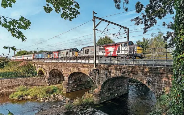  ??  ?? ‘Growlers' Nos. 37510 Orion and 37800 Cassiopeia plus No. 57312 rush over Six Arches Viaduct, Scorton, with the 1Z30 Workington to Chesterfie­ld return leg of Retro Railtours'
‘Retro Cumbrian Coaster 2' railtour on August 28. John Hales