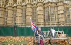  ?? — AFP ?? An anti-brexit demonstrat­or eats his lunch as he takes a break from protesting opposite the Houses of Parliament in London on Wednesday.