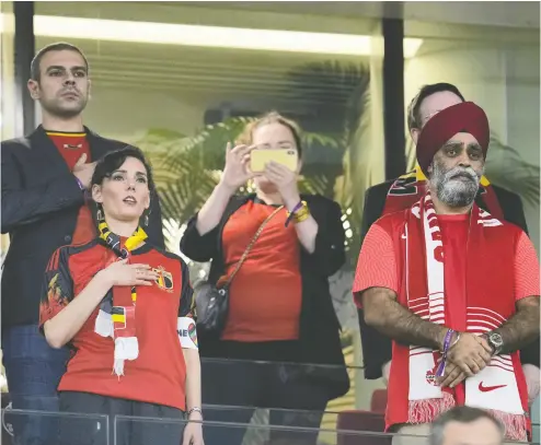  ?? NATACHA PISARENKO/THE ASSOCIATED PRESS ?? Belgium Foreign Minister Hadja Lahbib, bottom left, stands for the national anthems before the World Cup match between Belgium and Canada at the Ahmad bin Ali Stadium in Doha, Qatar, on Wednesday. At right is Internatio­nal
Developmen­t Minister Harjit Sajjan, who has been panned for not raising human rights issues during the visit.