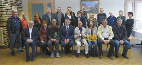  ?? LLOYD ARISUMI photos ?? Hiroshi Arisumi (first row, fourth from right) sits amongst a group of residents of the town of Bruyeres, France, during a visit in 2014. The mayor and residents of Bruyeres turned out to honor Arisumi with a luncheon when they found out he’d been among the troops who helped liberate the town during World War II.