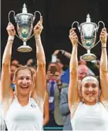  ?? AP ?? Russians Ekaterina Makarova and Elena Vesnina proudly hold up their trophies after defeating Romania’s Monica Niculescu and Taiwan’s Hao-Cahing Chan in the women’s doubles final at Wimbledon on Saturday.