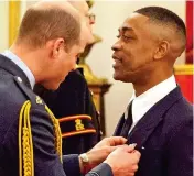  ??  ?? Award: Wiley gets his MBE from William