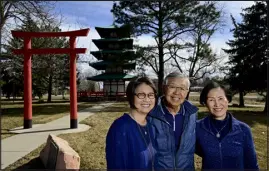  ?? MATTHEW JONAS — DAILY CAMERA ?? Gail Hogsett, from left, Ken Kanemoto and Karen Kanemoto Wood pose for a portrait near the Tower of Compassion at Kanemoto Park in Longmont on Tuesday. The tower, a symbol of kindness and solidarity, originally was donated to Longmont by the Kanemoto family in 1966 and finished in 1973.