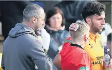  ??  ?? Outrage Assistant referee Calum Spence receives treatment after being struck by an object thrown from the crowd