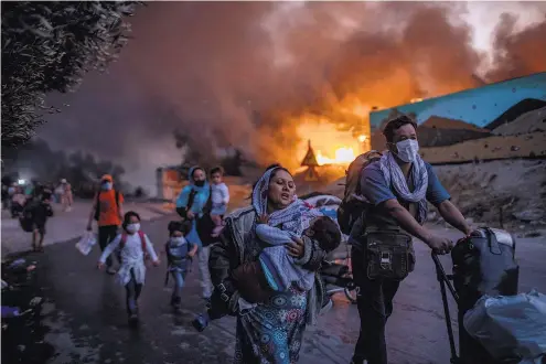  ?? ?? Migrants flee the Moria refugee camp on the island of Lesbos, in Greece, in September 2020.