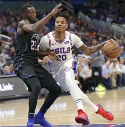  ?? JOHN RAOUX — THE ASSOCIATED PRESS FILE ?? Sixers backup point guard Markelle Fultz, right, here driving around Orlando’s Jerian Grant last week, plans to pay a visit to a shoulder specialist in New York and won’t practice or play until he does so.