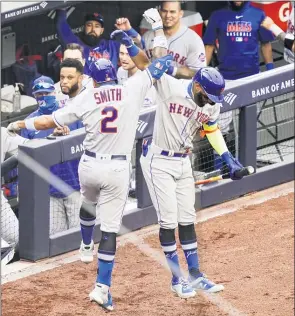  ?? JOHN MINCHILLO — THE ASSOCIATED PRESS ?? Mets’ Dominic Smith (2) celebrates with Amed Rosario (1) after hitting a goahead solo home run off Yankees relief pitcher Chad Green in the sixth inning of the first game of a doublehead­er on Friday.