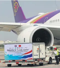  ?? SOMCHAI POOMLARD ?? The first delivery of Covid-19 vaccines arrives in Thailand. The AAT wants the government to prioritise air crew vaccinatio­n.