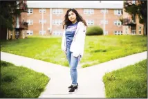  ?? (AP) ?? In this April 3 photo, Anali Reyes Vazquez a senior at Rutgers University­Camden senior poses for a photograph in Barrington, NJ. For health sciences major Vazquez, the sweeping turmoil has brought setbacks as her
parents are out of work, but also a glimmer of opportunit­y.