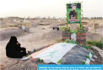  ??  ?? BAGHDAD: An Iraqi woman visits the grave of a relative, who was killed during battles with Islamic State (IS) group fighters, at a graveyard in the Iraqi town of Dhuluiyah. — AFP