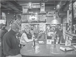  ?? PHOTOS BY KYLE GRANTHAM/DELAWARE NEWS JOURNAL ?? Patrons fill the bar at the Stone Balloon Ale House in Newark in 2015.