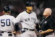  ?? JARED WICKERHAM/GETTY IMAGES ?? Alex Rodriguez of the Yankees is tended to by a trainer after being hit by a pitch Sunday at Fenway Park in Boston.