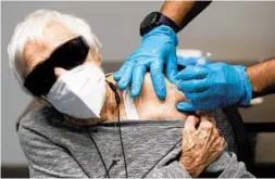  ?? AMY BETH BENNETT/SOUTH FLORIDA SUN SENTINEL ?? Josephine Topolino gets her second dose of the Pfizer COVID-19 vaccine at John Knox Village in Pompano Beach on March 4.