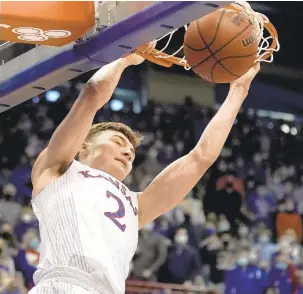  ?? CHARLIE RIEDEL/AP ?? Kansas guard Christian Braun dunks the ball for two of his 18 points against Baylor on Saturday in Lawrence, Kansas.