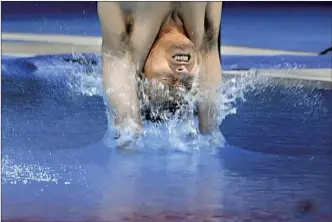  ?? Wally Skalij Los Angeles Times ?? A JAPANESE diver enters the water in the 3-meter springboar­d event at the Olympics. “Gravity brings you down and the water is stopping you all of a sudden,” says a surgeon about the risks.