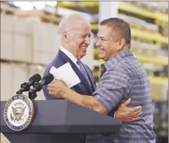  ??  ?? VICE PRESIDENT Joe Biden embraces Bobrick employee Rigoberto Hernandez, who has worked for the company for 29 years.