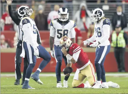  ??  ?? KARL MONDON — BAY AREA NEWS GROUP San Francisco 49ers quarterbac­k Jimmy Garoppolo (10) was sacked by the Los Angeles Rams five times including this one in the fourth quarter, Dec. 21, 2019, at Levi’s Stadium in Santa Clara.