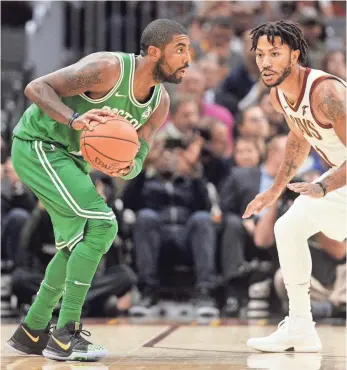  ?? KEN BLAZE, USA TODAY SPORTS ?? Celtics guard Kyrie Irving, left, works against Cavaliers guard Derrick Rose during the first quarter Tuesday. Irving finished with 22 points against his former team.