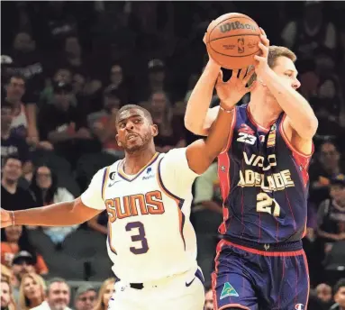  ?? PHOTOS BY ROB SCHUMACHER/THE REPUBLIC ?? Phoenix Suns guard Chris Paul pressures Adelaide 36ers forward Daniel Johnson at Footprint Center on Sunday.