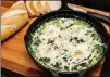  ?? CONTRIBUTE­D BY HENRI HOLLIS ?? Skillet-baked Eggs with Spinach.