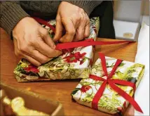  ?? AKRON BEACON JOURNAL / TNS ?? While traditiona­l gift-wrapping isn’t likely to just disappear, companies are bound to adapt and reconsider non-recyclable materials, such as glitter and cellophane.