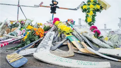  ?? BRANDON HARDER ?? Mourners have created a memorial to the Humboldt Broncos by leaving hockey sticks and flowers at the site of the April 6 bus crash between Nipawin and Tisdale. Sixteen people on the bus were killed, another 13 injured.