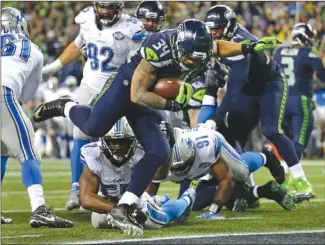  ?? The Associated Press ?? Seattle Seahawks running back Thomas Rawls rushes for a touchdown against the Detroit Lions in the second half of an NFL wild-card playoff game Saturday in Seattle. The Seahawks won 26-6.